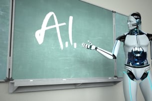 A shiny silver human-like robot stands pointing at a green chalkboard, where "A.I." is written in white chalk.