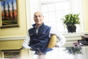 A smiling David Wippman sitting at a desk