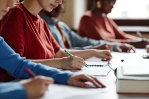 Students work on a writing assignment in a classroom