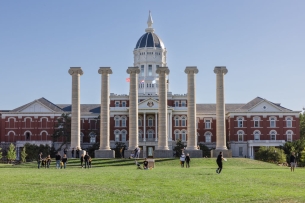 Four pillars in front of a domed building