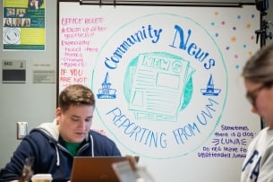 Students working in the Center for Community News room