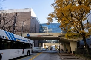 A bus passes under a sign on Georgia State University's campus in Atlanta, Georgia.