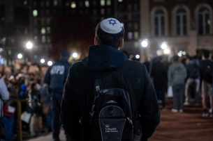 Jewish student looks on at pro-Palestinian protesters