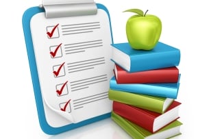 Stack of books with an apple on top sits beside a clipboard with a checklist