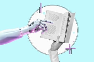 A robot hand points to a book. The book is being held by a human hand. 