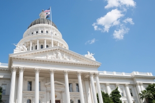 An image of the California Capitol Building with its prominent white columns and dome.