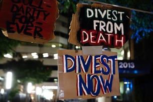 A photo of protest signs calling for divestment.