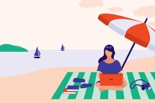 Woman sitting at beach working on computer with several books beside her