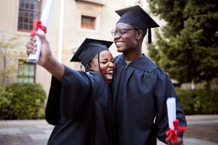 Two Black students celebrate their graduation