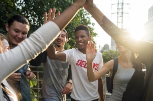 A group of friends hanging out, giving high fives