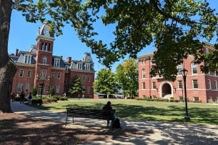 A photograph of West Virginia University's central quad, with Woodburn Hall on the left.