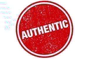 A circular red and white badge with the word "Authentic."