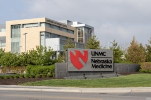 A photo of a University of Nebraska Medical Center building, with its sign in front.