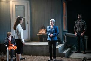 A darkly lit image of four actors on stage during the Studio Theatre’s 2022 production of Will Arbery's "Heroes of the Fourth Turning."