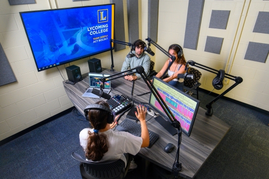 Students in a podcast studio
