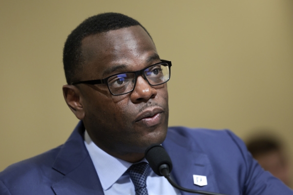 Former Jackson State University president Thomas Hudson, a dark-skinned man, from the chest up, wearing a jacket and tie and square-framed glasses.