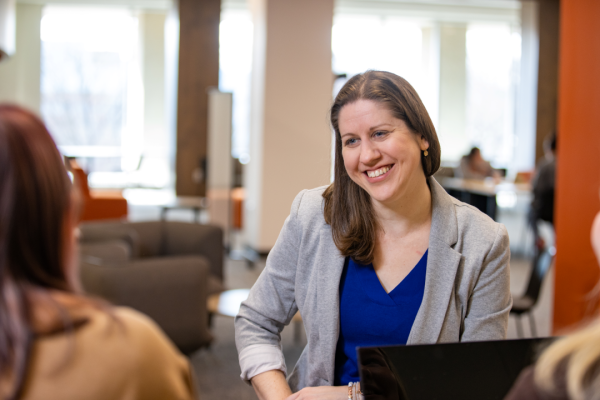 Adrienne Ausdenmoore speaks with a student in the Radbill Center.