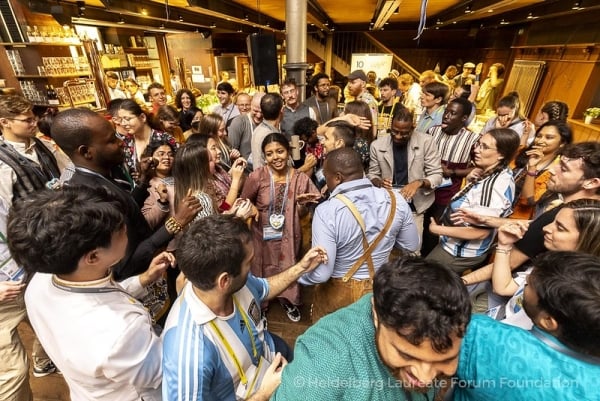 Students of different nationalities and genders dance in close proximity.