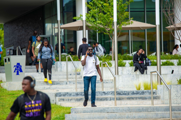 Students walk down steps on a campus