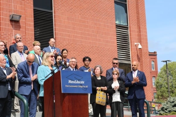 Massachusetts Senate President Karen Spilka and others standing at a podium outside Middlesex Community College.