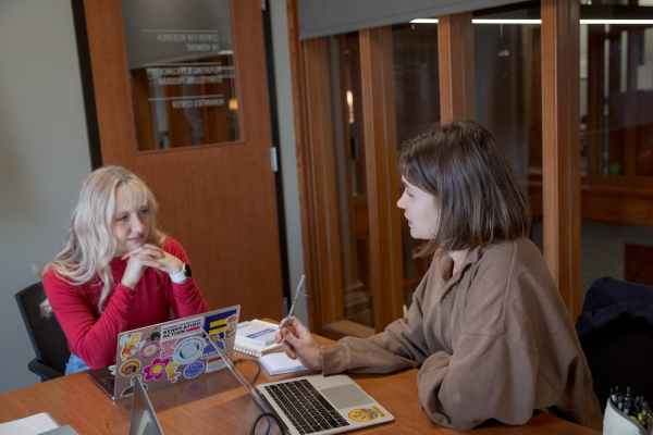 Charlotte Oliver works with another student journalist