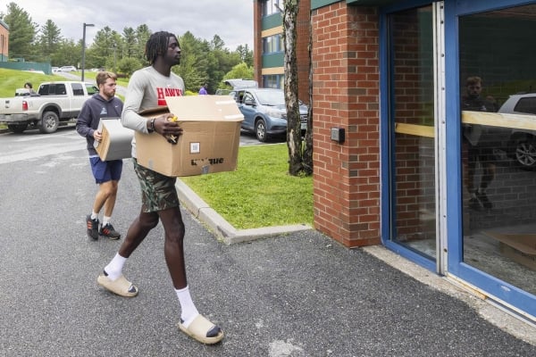 A student with a box near a door