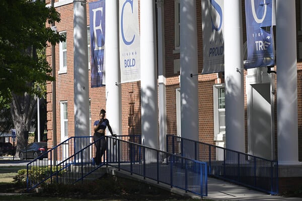 A student stands next to a building on the campus of Elizabeth City State University in Elizabeth City, N.C.