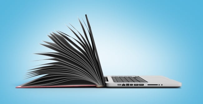 Concept photo of an open gray laptop on the right that opens up and becomes a book with pages on the left. Background is blue. 