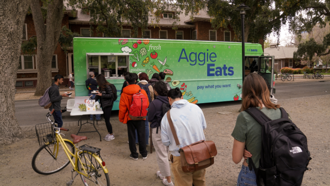 Students line up to receive a meal from the AggieEats food truck.