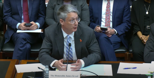 Under Secretary James Kvaal, a light-skinned man with gray hair, sits a table during a House hearing.