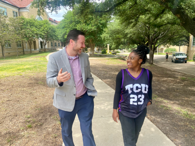 Jason Titus engages with a student on Texas Christian University's campus.