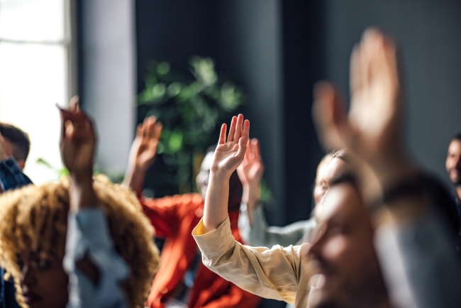 Students raise their hands in a seminar