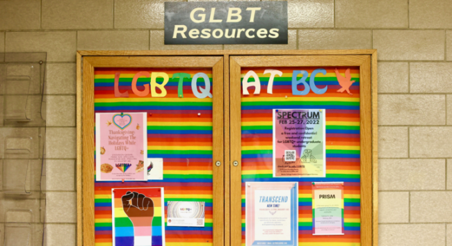 A rainbow-covered board at BC advertising LGBTQ+ resources