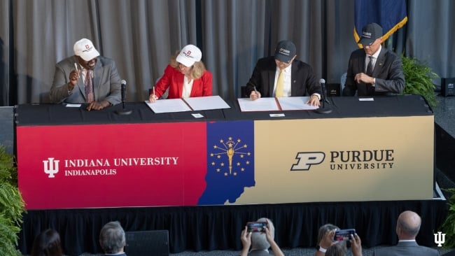 A photo of Indiana University and Purdue officials signing an agreement to split IUPUI into two institutions.