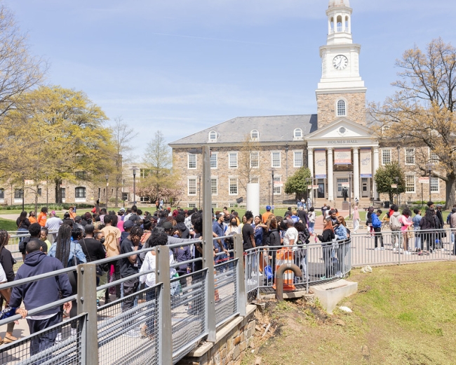 A line of prospective students stands in front of an academic building on Morgan State University's Baltimore campus. 