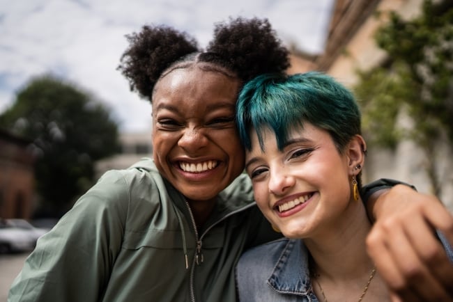 Happy Athletic Friends Hugging Each Other And Smiling. Girls Are