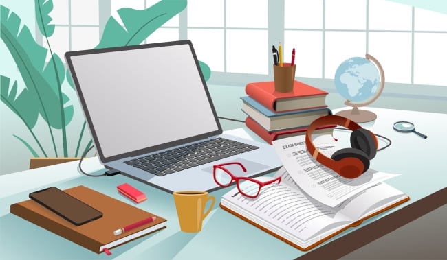 desktop with open computer, books, papers, eyeglasses and pen and pencil holder