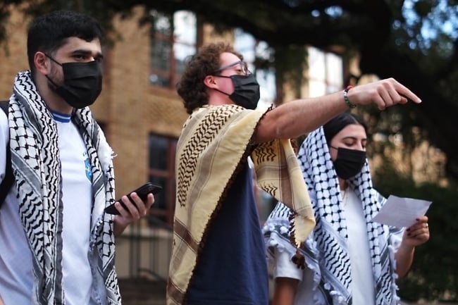 Three student demonstrators at a Dec. 8 protest of the University of Texas at Austin's removal of two teaching assistants.