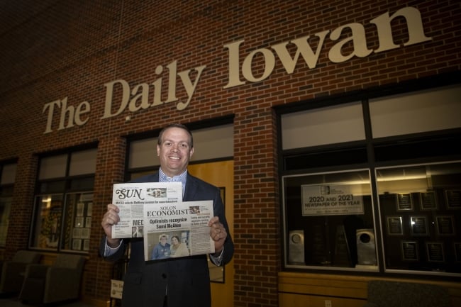 Jason Brummond holds copies of the Solon Economist and the Mount Vernon-Lisbon Sun.