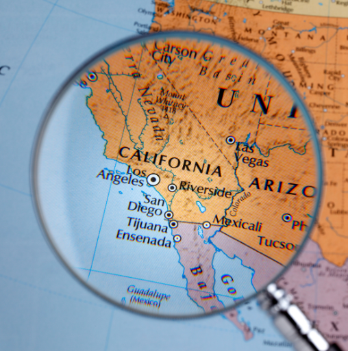 A map of the U.S. with a magnifying glass over California.