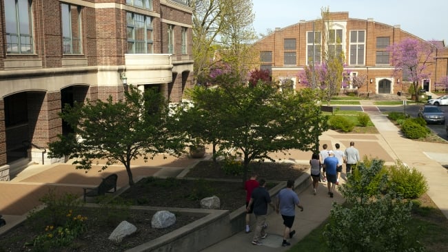 People walk on Drury University’s campus on a sunny day