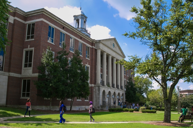 Students walk in front of an academic building at Tennessee State University on a sunny day. 