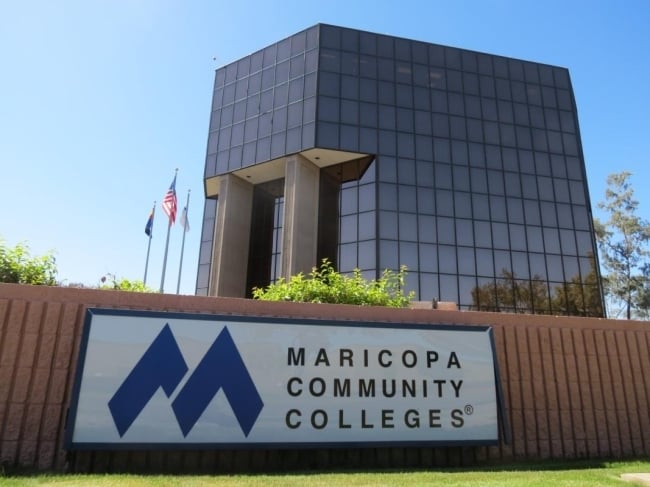 A sign reads “Maricopa Community Colleges” in front of an administrative building.