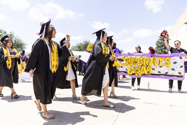 Austin Community College graduates walk to their ceremony on May 17, 2024, in Cedar Park, Texas.