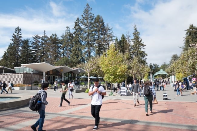 Students walk through the campus of UC Berkeley in downtown Berkeley, California on Sather Road.