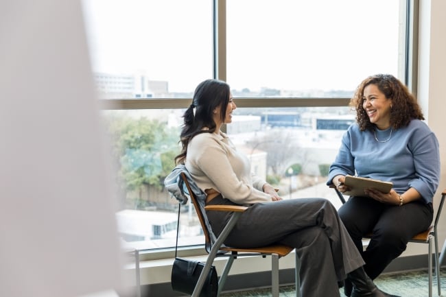 Businesswomen sit together and talk in the office