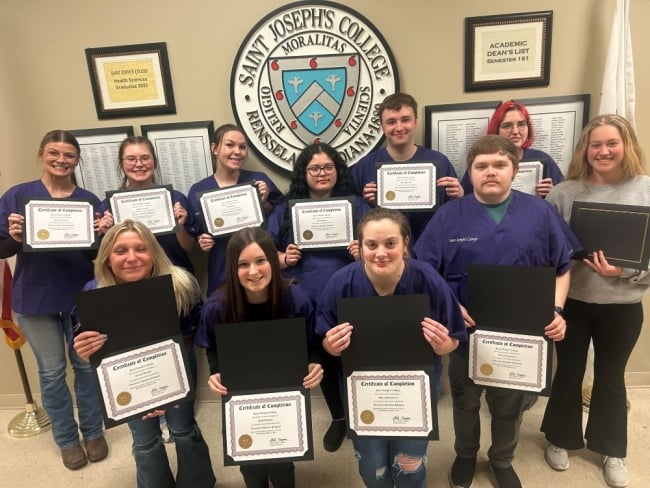 A group of veterinary assistant program students at Saint Joseph's College pose with their certificates.