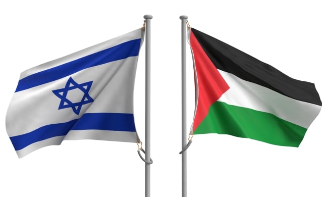 Two flagpoles, one with an Israeli flag and one with a Palestinian flag, stand next to one another.