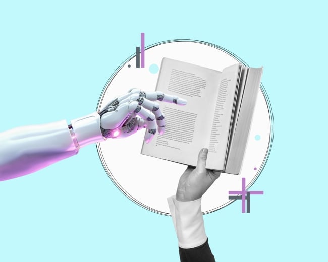 A robot hand points to a book. The book is being held by a human hand. 