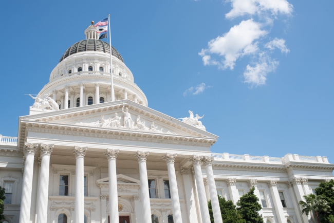 An image of the California Capitol Building with its prominent white columns and dome.